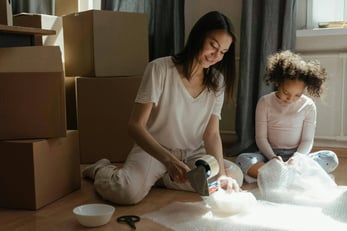 Mom and daughter packing items 